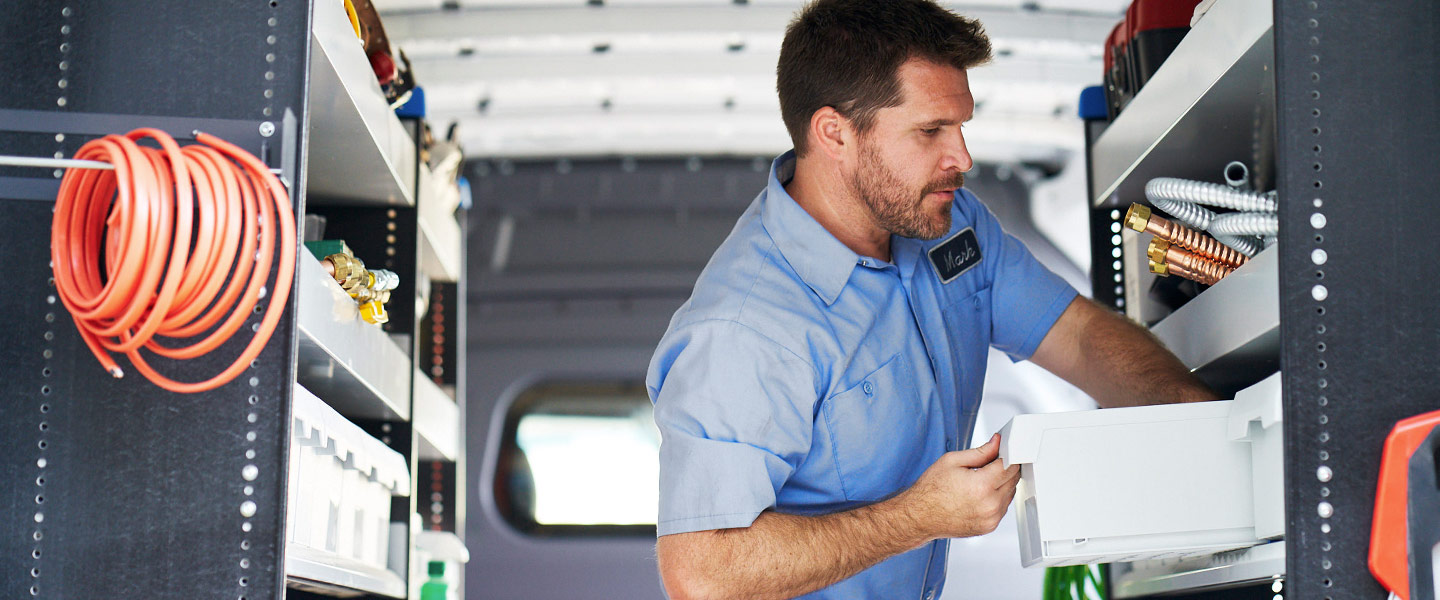 A man working in the back of a Sprinter Cargo Van